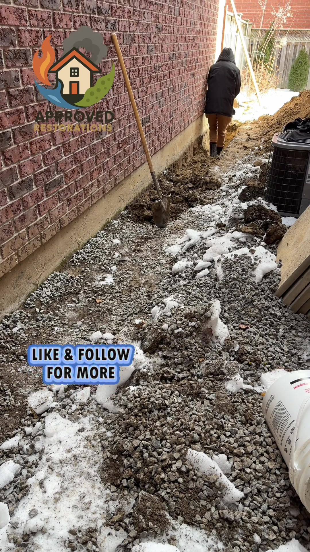 A major foundation crack is actively leaking water into this homeowner's basement, so our crew has no choice but to tackle the repair in the middle of winter, hand-digging through the snowy but unfrozen earth along the exterior brick wall to expose the damage and fix the waterproofing.