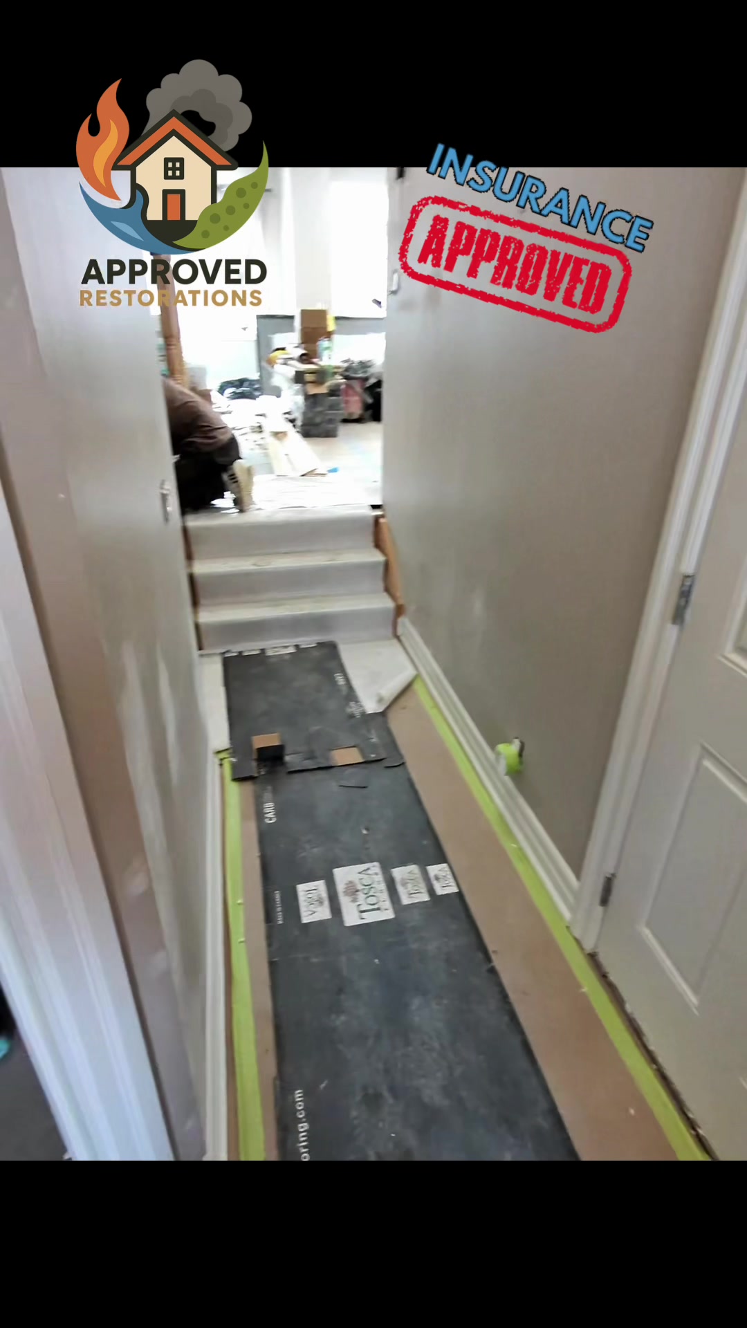 An upstairs bathroom leak poured through the ceiling and destroyed the kitchen and basement of this Vaughan home, so after tearing out the ruined island and finishing the new floors, our crew is taping down protective paper over the freshly stained stairs to keep everything pristine before the replacement kitchen arrives.