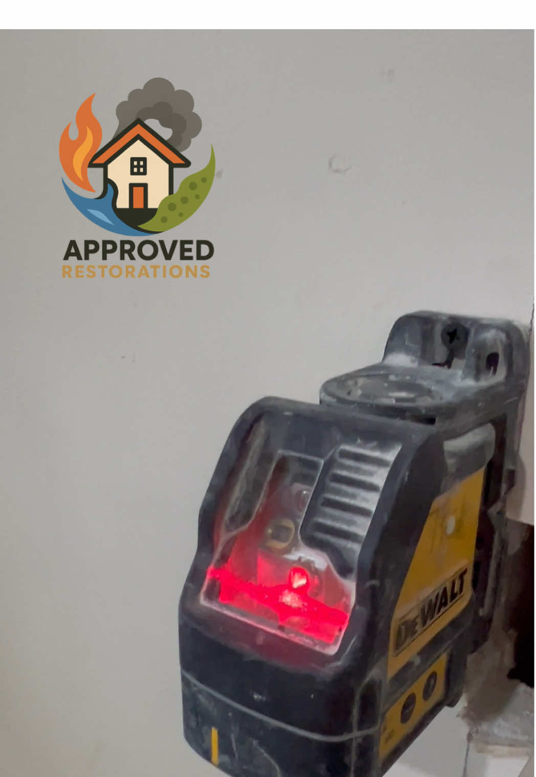 During this upper-floor bathroom restoration in Newmarket, our crew is shooting a red laser line across the fresh green board to keep every seam perfectly plumb as we set large-format marble tiles around the tub, lock in the leveling wedges, and push this top-to-bottom rebuild toward the finish line.