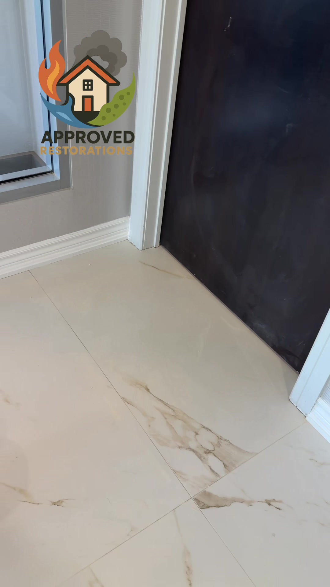 After tearing out the aftermath of water damage and mold in this condo, our crew is tackling the final clean-up process on a brand-new tile installation, sweeping away the last of the debris to ensure the fresh grout lines look perfect before we officially mark this reconstruction project complete.