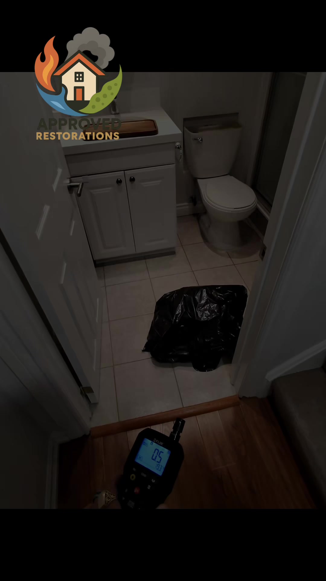 Responding to a 3 AM emergency call from a homeowner who returned to a flooded basement, our team is using thermal cameras and moisture meters to track a severe bathroom leak—and after finding 100% saturation in the ceiling, we are mapping the water's path into the adjacent storage room to tear out the bowing laminate flooring.