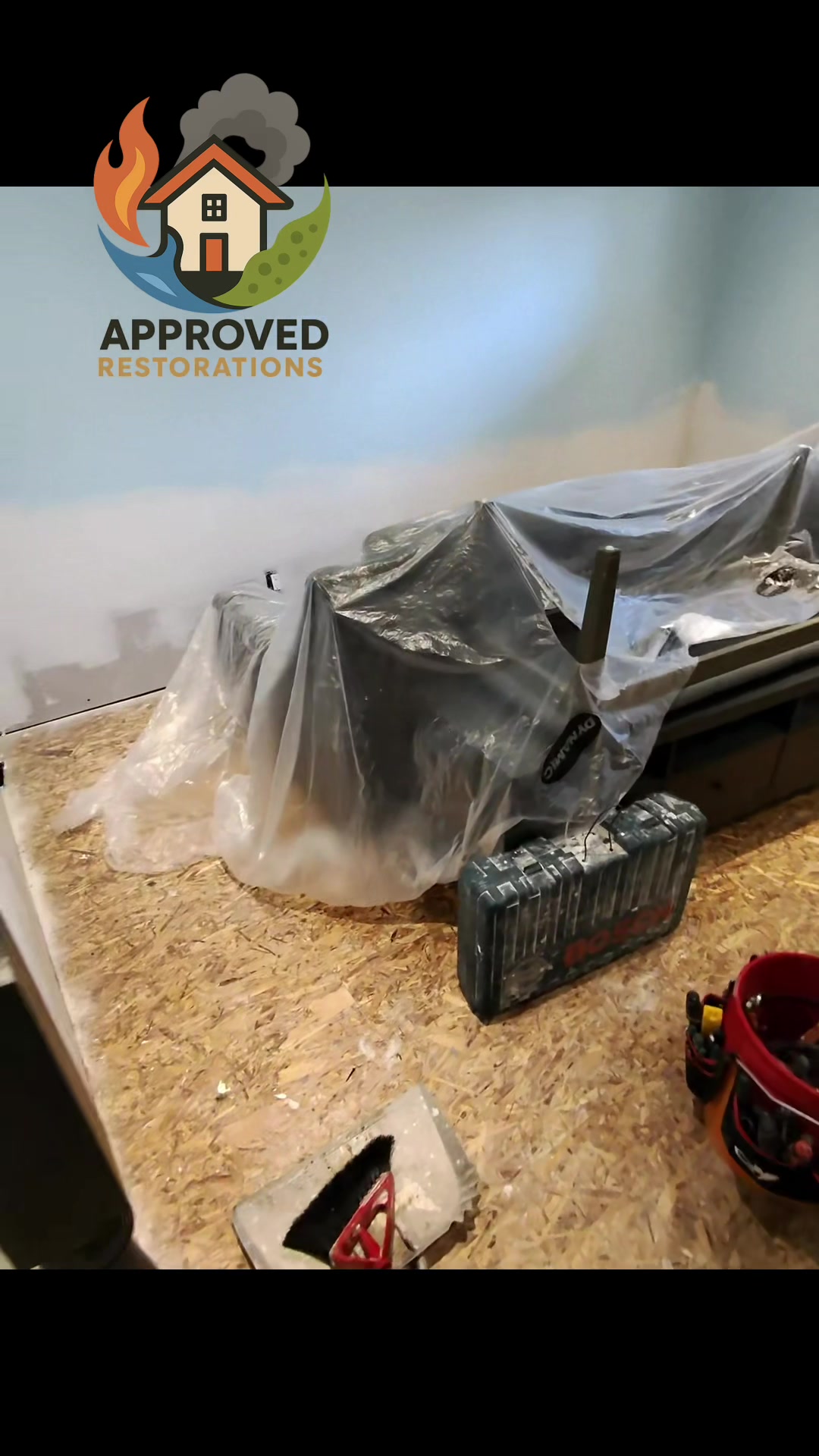 A sump pump failure flooded this finished basement, so our team immediately jumped into mitigation mode—tarping the remaining furniture with heavy plastic, slicing out the saturated lower drywall, and exposing the bare OSB subfloor to ensure the framing dries completely before we begin the rebuild.