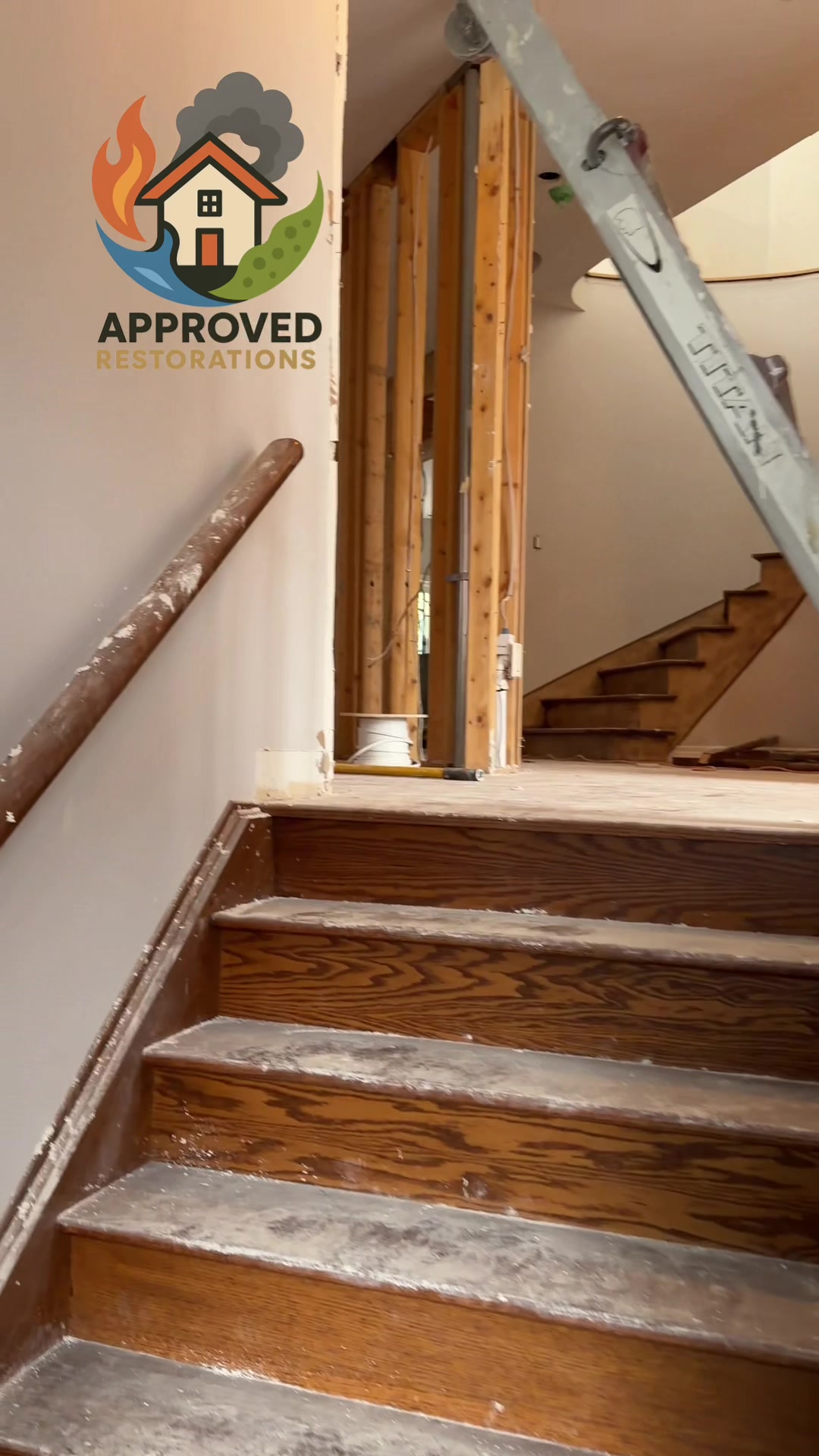 Handling a massive water damage claim at this Vaughan home, our crew is stripping the second-floor landing down to the bare studs and staging ladders to reach the ceiling, hauling out the soaked drywall so we can thoroughly dry the exposed framing before launching into major renovations.